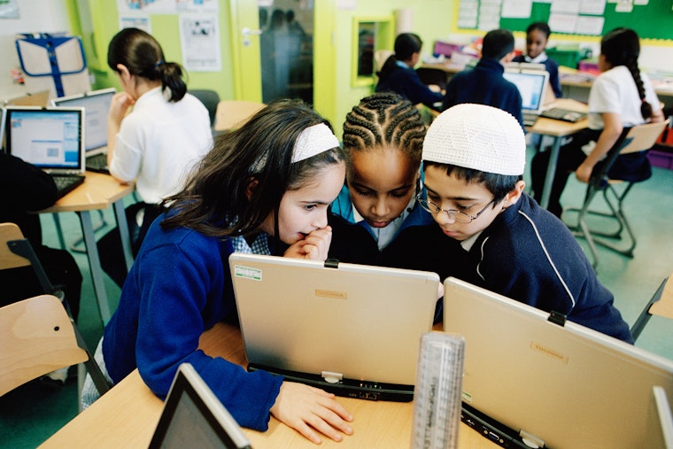 Students gathered around a computer