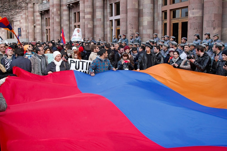 Demonstrators holding Armenian flag