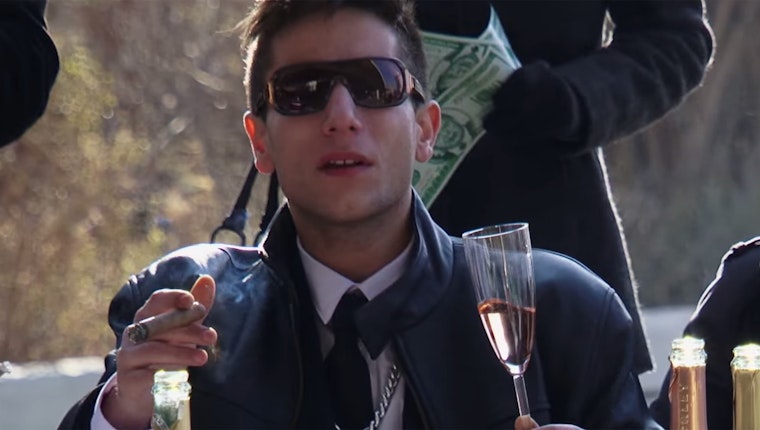 Still image from “Drug Lords Celebrate the Drug War at the UN!” Fictional drug lords celebrate the anniversary of the international drug control system. Actors portraying drug lords