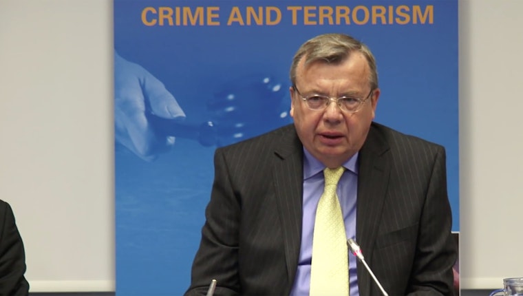 Still image from “The Russian Drug Czar vs. Methadone: Parcel of Lies.” The HCLU questioned why opiate substitution treatment is still unavailable in a country facing a drug-related HIV epidemic. Man speaking at a microphone