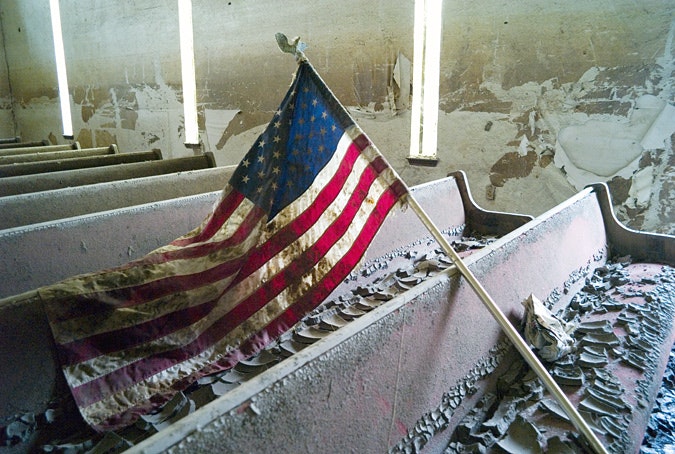 U.S. flag lies across pews of damaged church