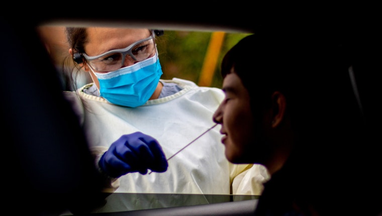 A boy is tested COVID-19 with a nasal swab