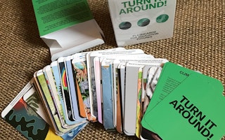 Turn It Around! Flashcards for Education Futures, a deck of educational flashcards for adults with art and messages about the climate crisis by youth from around the world. Photo credit: Courtesy of Artists Literacies Institute A stack of cards, with "Turn it Around!" on one