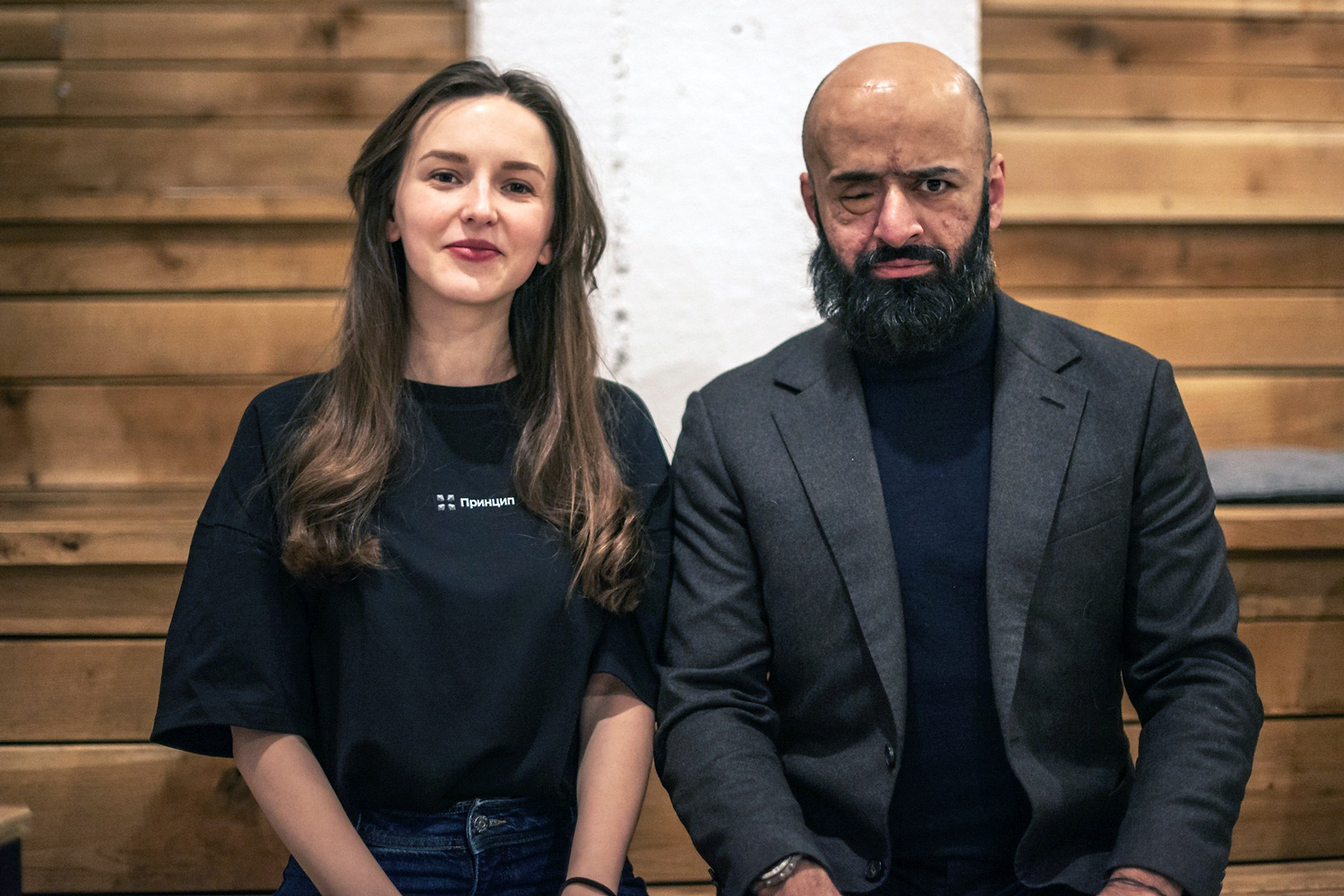 A woman stands on the left and a man on the right