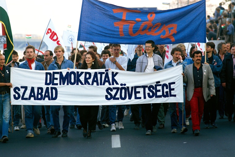 People marching holding Fidesz flags and banners