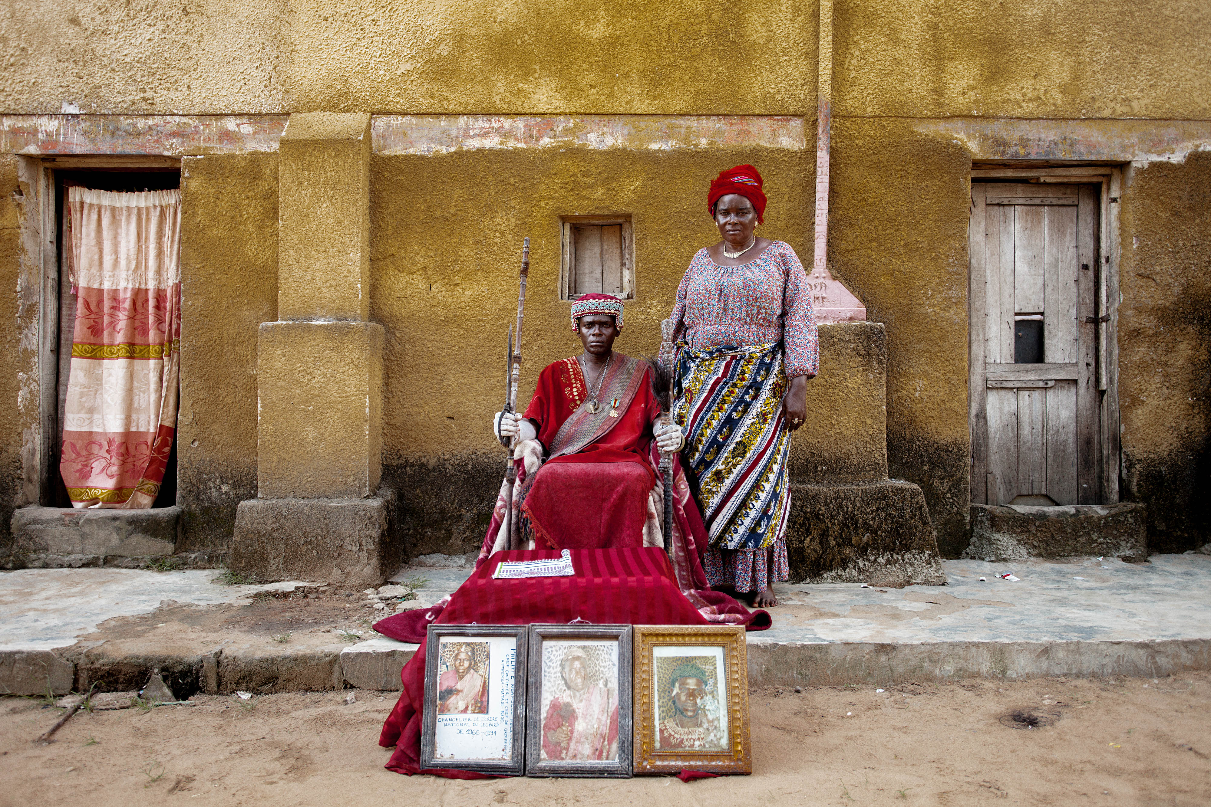 A man and a woman pose outside a building