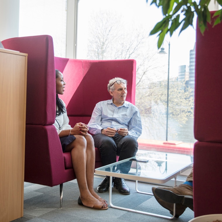 Image Two people sitting in a chair
