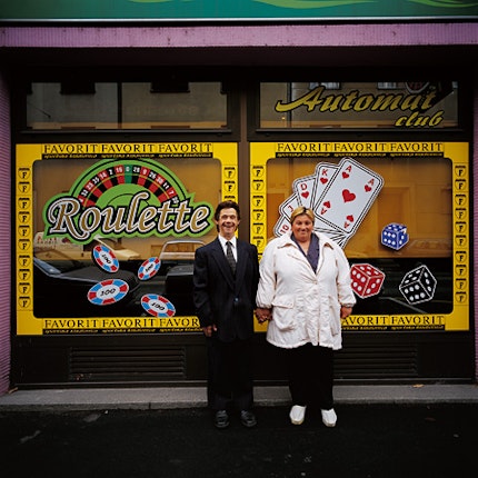 Čičič and her husband holding hands outside an “automat club”