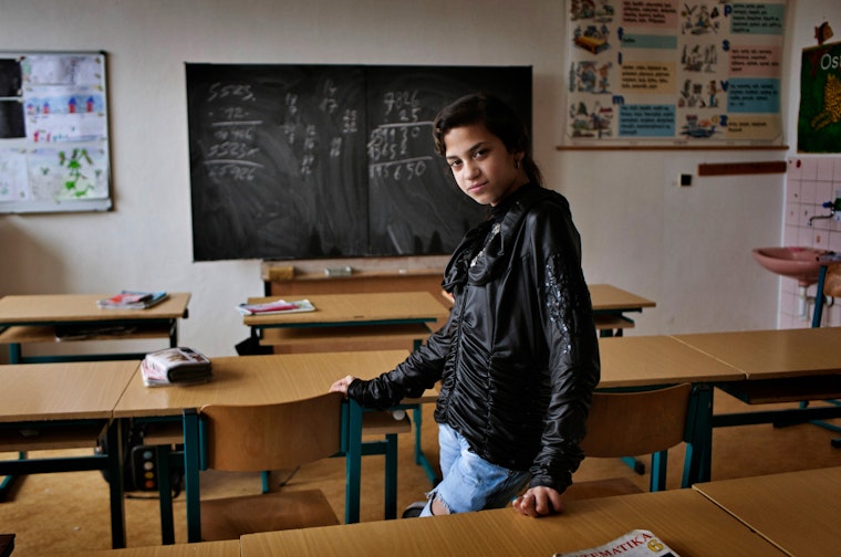 A student stands in a classroom.