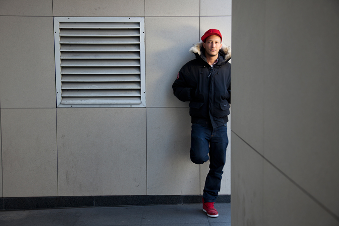 A young man leaning against a wall