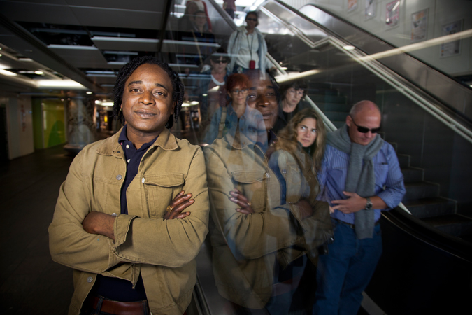 A man leaning against a glass door