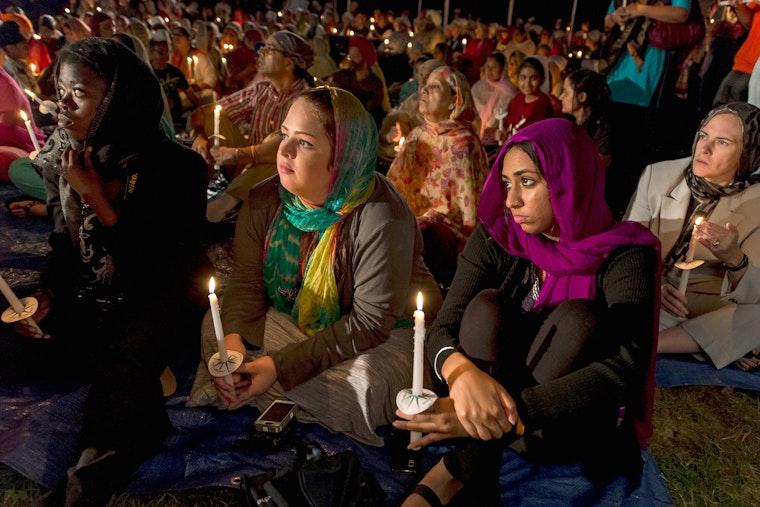 People holding candles at a vigil