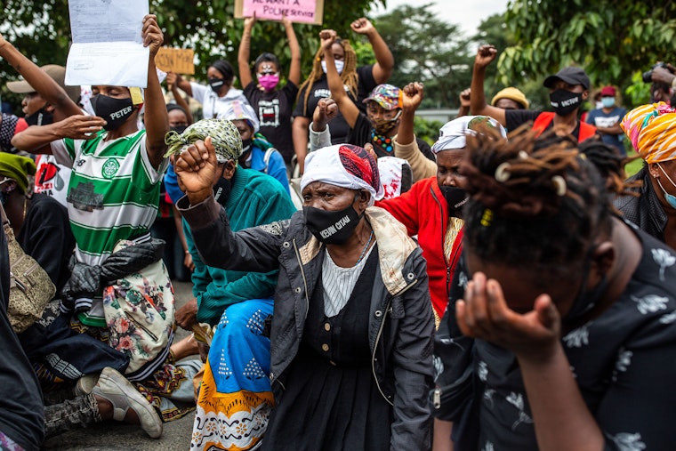 A woman raises her fist at a protest