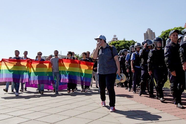 Participants in the Kyiv Equality March on June 6, 2015, walk past a row of police officers assigned to protect them. Photo credit: © Sergii Kharchenko/Newscom Demonstrators marching with police protection