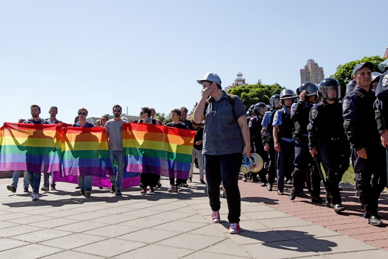 Demonstrators marching with police protection