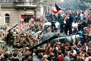 A crowd surrounds tanks
