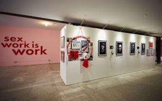 View of art exhibition with the words; Sex Work is Work, on the wall