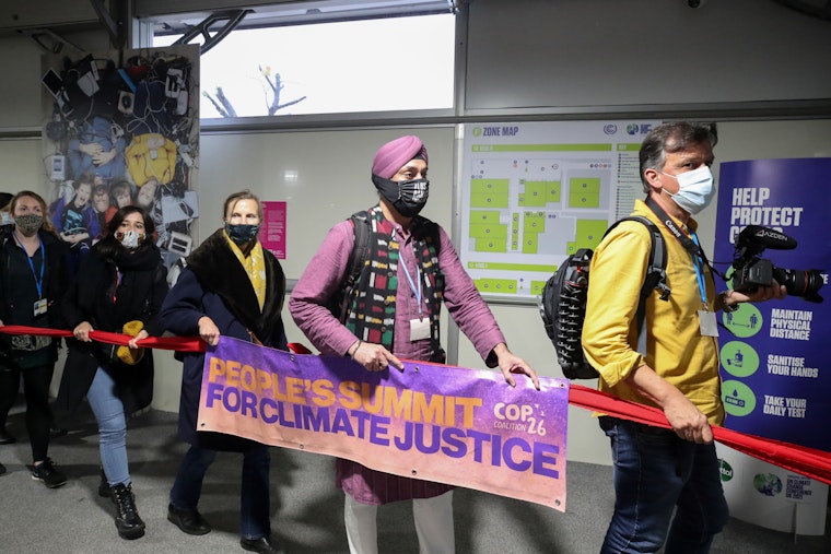 Protestors with sign reading "People's Summit for Climate Justice"