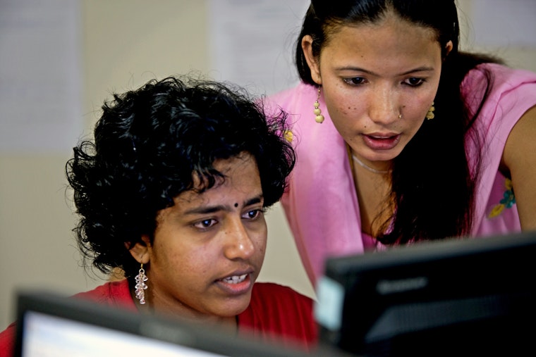 Students from India and Nepal work in one of the IT labs at the Asian University for Women in Chittagong, Bangladesh, in July 2008. Photo credit: © Majority World/Getty Two women at a computer