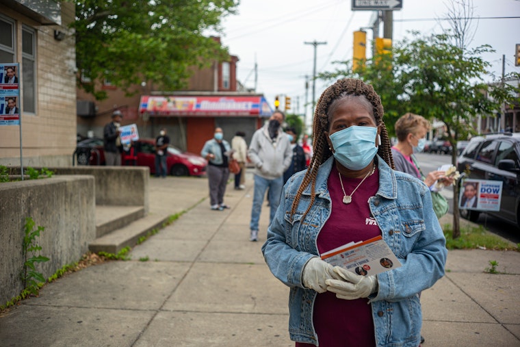 A woman waits in line to vote, in Philadelphia, Pennsylvania, on June 2, 2020. Photo credit: © Jessica Kourkounis/Getty A woman stands in line.
