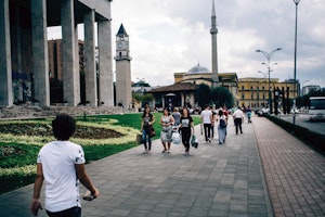 People walk along downtown Tirana, Albania, on December 4, 2015. Photo credit: © Alessandro Rampazzo/LUZ/Redux People walking on a sidewalk