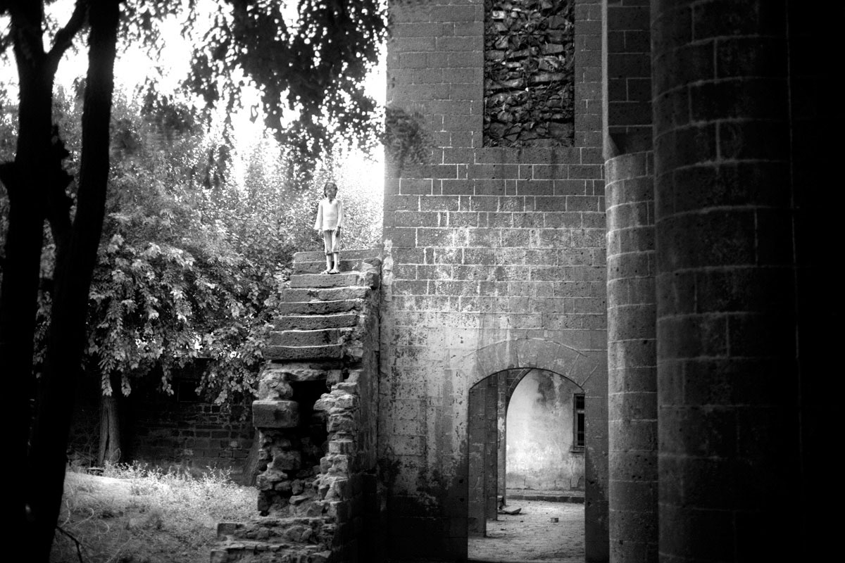 A young girl stands on ruin in Turkey.