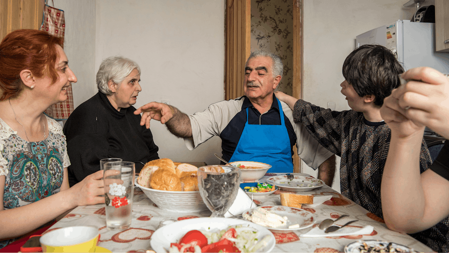 Members of a community-based home share lunch together in Tbilisi, Georgia, on June 22, 2016.