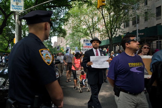 Man walking with sign by police officer
