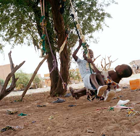 Kids playing on a tire swing