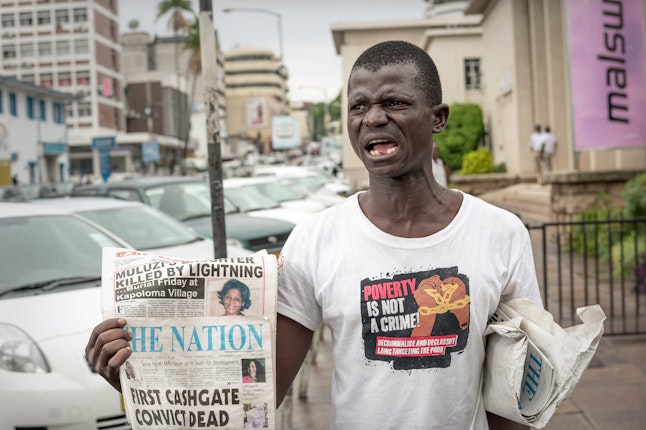 A man selling newspapers