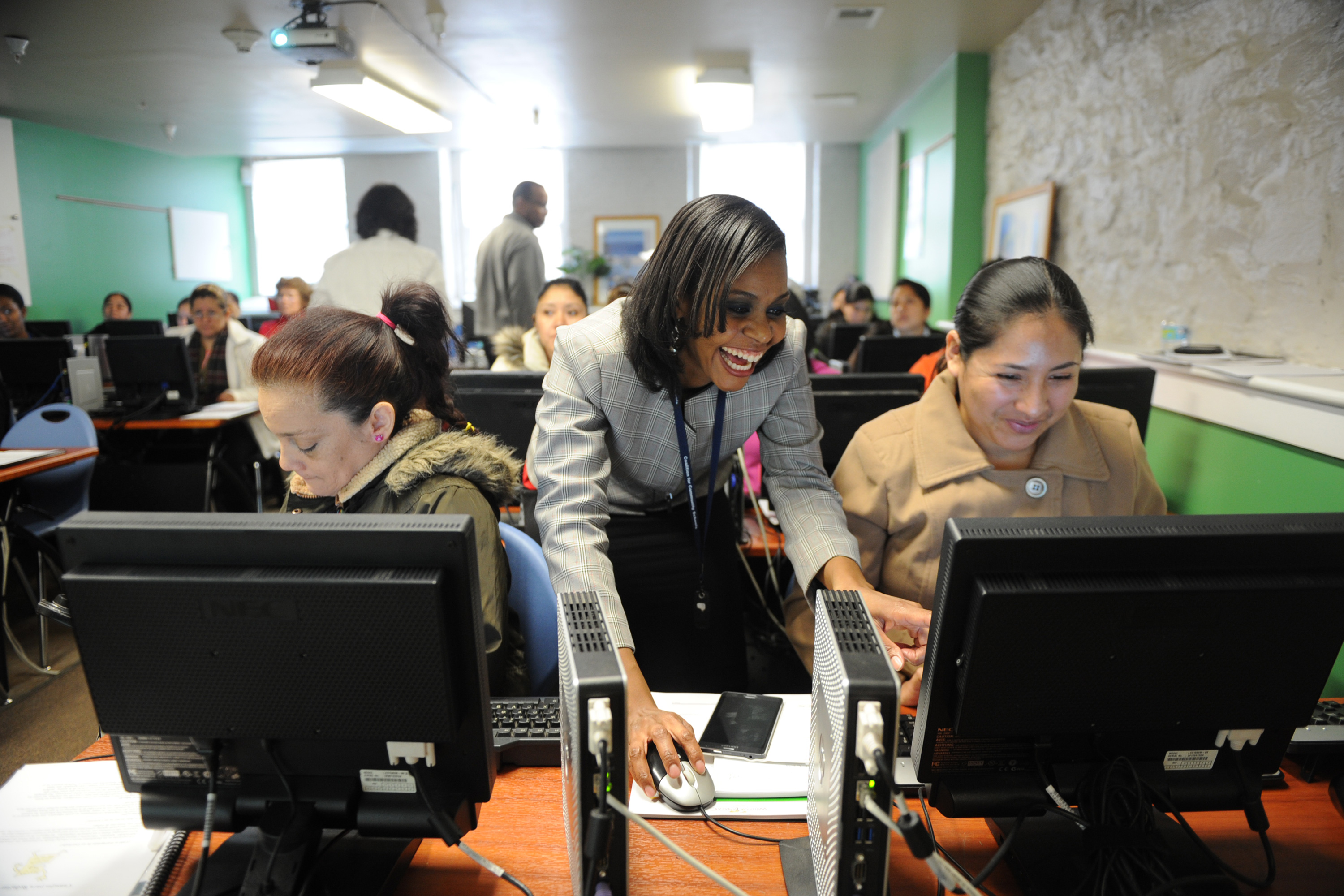 Adults at computers in a computer lab.