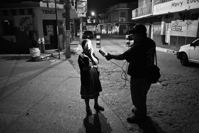 A woman gets interviewed by a local freelance reporter in Guatemala City after a double homicide took place. Newspapers and commercial broadcasters are boom businesses in emerging markets like Brazil and India, but in the old, affluent democracies, news journalism increasingly looks like a sunset industry. Photo credit: © Carlos Javier Ortiz/Redux A journalist interviewing a woman