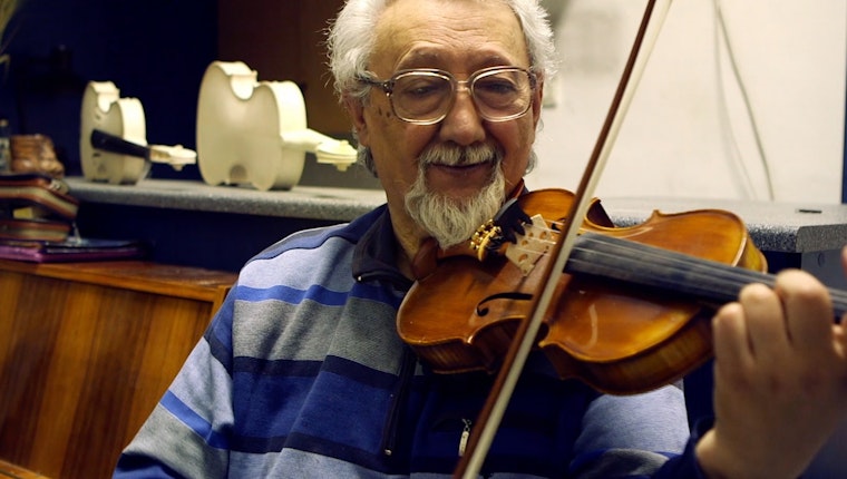 Still image from “Hungarian Roma: A Cultural Heritage.” Man playing a violin