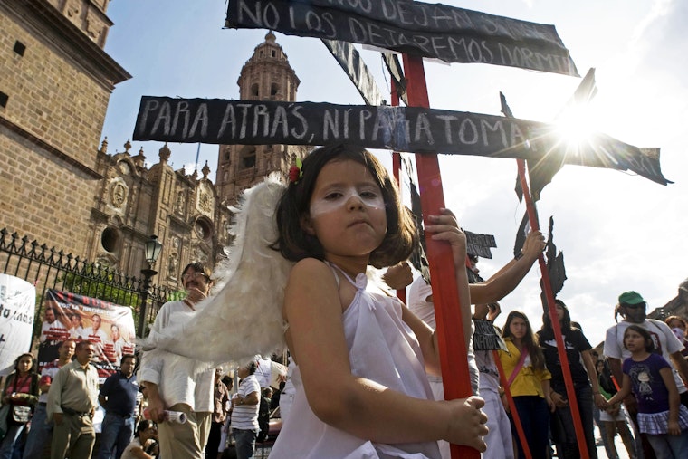 Children participate in the Caravan for Peace with Justice and Dignity in Morelia, Mexico, on June 4, 2011. Photo credit: © Porfirio Gonzalez/Getty A young girl dressed as an angel at a rally