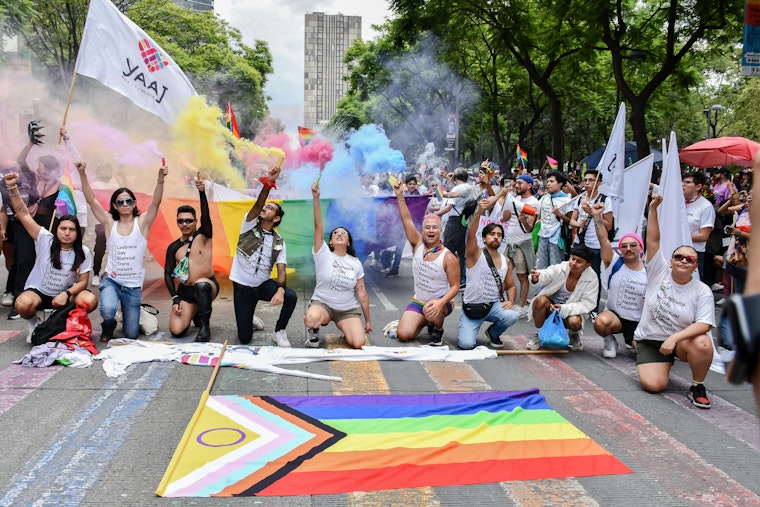 Alejandra Paredes, far right, poses with other Yaaj activists during the Mexico City Pride march on June 29, 2024.
© Sylvia Cortés for Yaaj México A group of people stand in front of a pride flag at a march