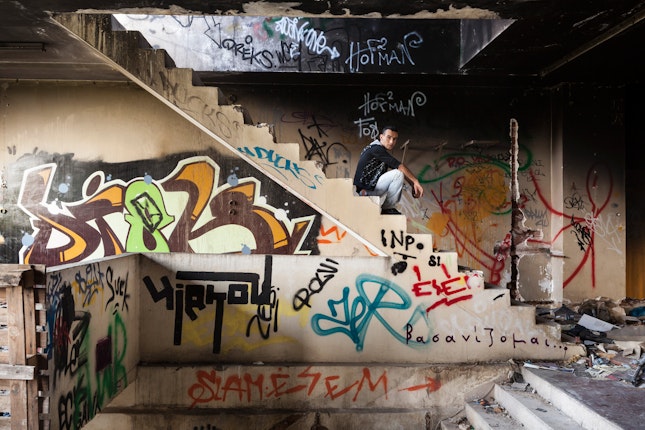 Man on stairs in abandoned building