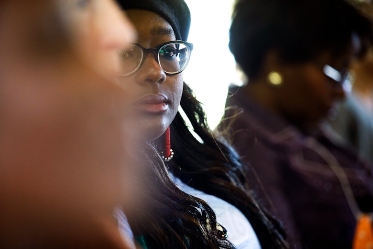 A woman participating in a workshop in Johannesburg, South Africa, on June 19, 2018. Photo credit: © Marc Shoul/Panos for the Open Society Foundations A woman looks at the camera through a crowd.