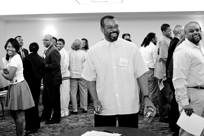 Estrus Tucker laughing among group of people