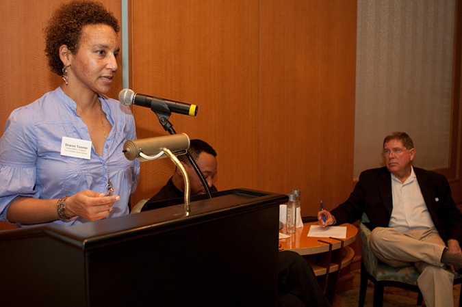 Sharon Toomer speaks into microphone at podium