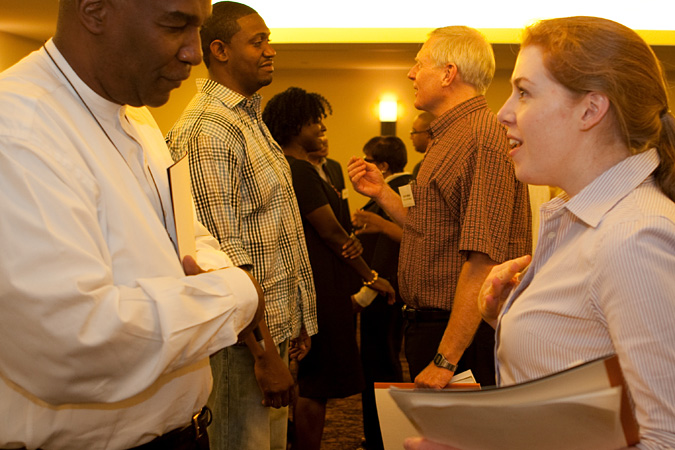Reverend Alfonso Wyatt and Gretchen Dovholuk talking among others