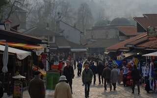 A crowd of people walking in a market