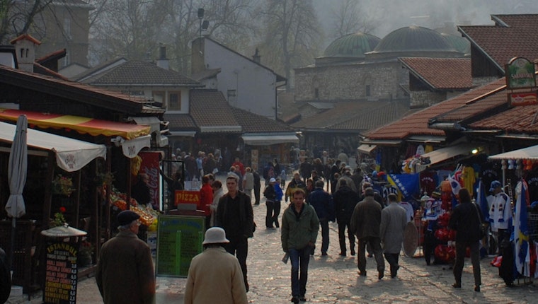 A crowd of people walking in a market