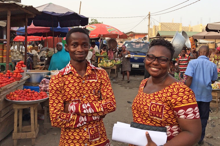 Two bankers in a market in Ghana
