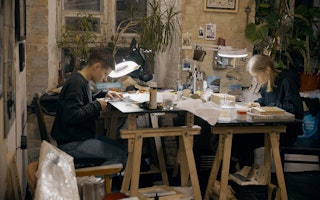 Kristina Yarosh and Anna Khodkova working in an art studio.