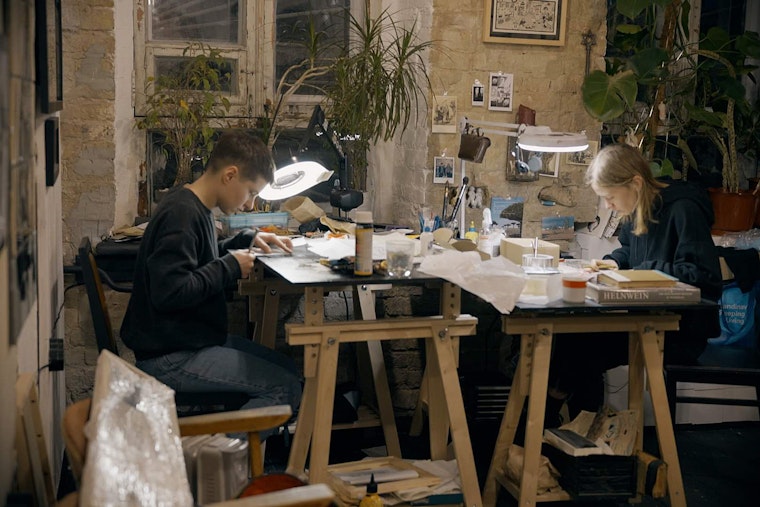 Kristina Yarosh and Anna Khodkova working in an art studio.