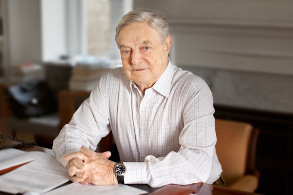 George Soros sitting at a desk