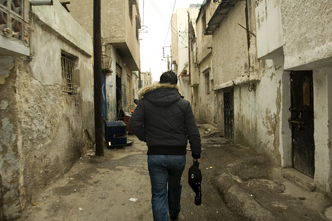 Man walking down narrow street
