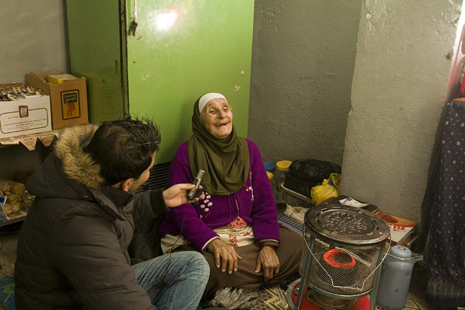 Man with microphone interviewing woman