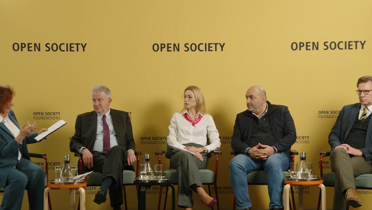 Panelists sitting on a stage