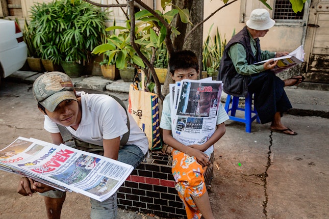 With the relaxation of censorship, newsstands have sprung up all over Burma, including this one near 49th Street in downtown Yangon, Burma on December 13, 2012. Still, challenges remain. Some newly un-censored publications have reported the possible hacking of journalists’ email accounts by the government. The government denies the allegations. Photo credit: © Ed Kashi/VII for the Open Society Foundations Boys sitting with newspapers